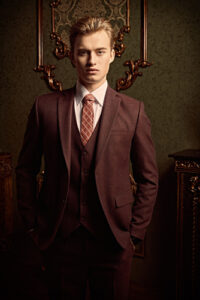 Model wearing Brown 3-Piece Suit Red Tie